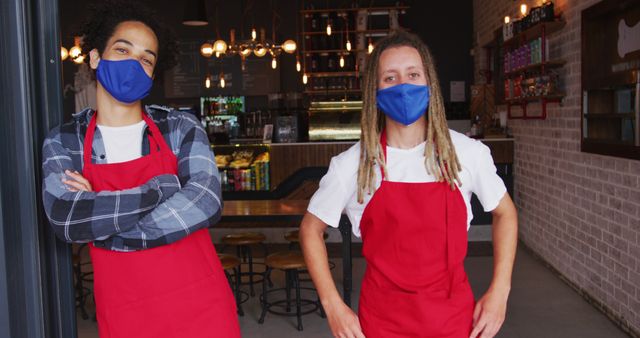 Baristas wearing face masks and red aprons in cafe - Download Free Stock Images Pikwizard.com