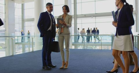 Modern Business Executives Discussing Digital Strategy in Office Lobby - Download Free Stock Images Pikwizard.com