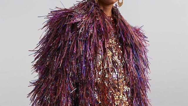 Iridescent purple fringe jacket with gold sequin top and statement hoop earring