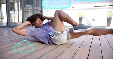 Young man doing bicycle crunch on rooftop deck with teal cloud fitness overlays