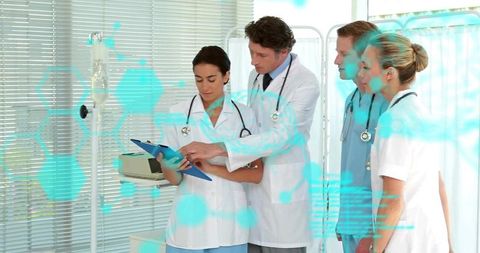 Medical team reviewing chart with ar overlay, physicians collaborating