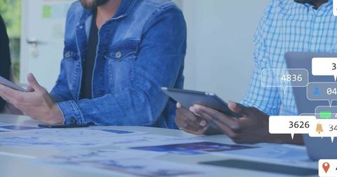 Team of Professionals Analyzing Data with Digital Interfaces