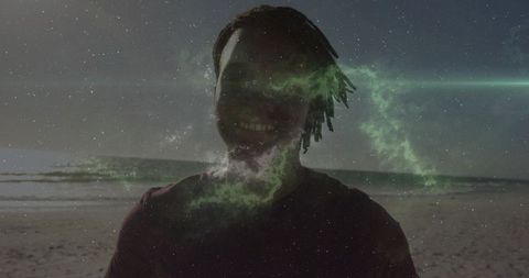 Surreal beach silhouette with green nebula overlay at twilight, cosmic portrait concept