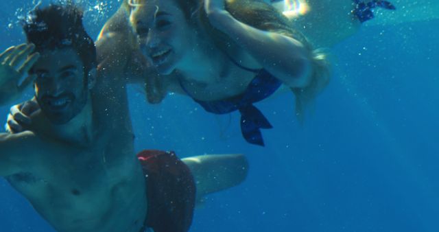 Happy Couple Swimming Underwater in Pool - Download Free Stock Images Pikwizard.com