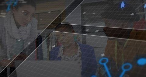 Fashion designers reviewing tech-driven garment designs on laptop with holographic grid