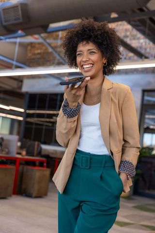 Businesswoman engaged in phone communication at office