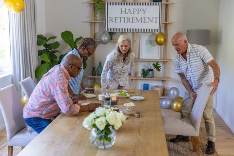 Senior Coworkers Arranging Retirement Party with Food and Decorations