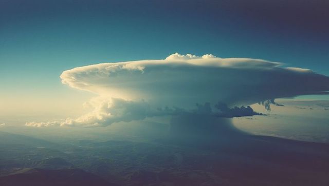 Dramatic Cumulonimbus with Anvil Cloud Formation Over Farmland