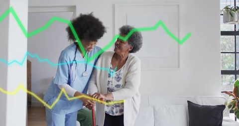 Caregiver in blue scrubs assisting senior woman with mobility aid at home