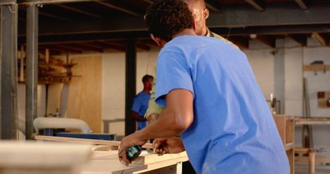 African American Workers Collaborating in Woodshop Environment