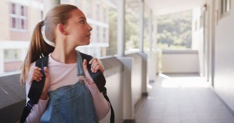 Female Student with Backpack in School Hallway
