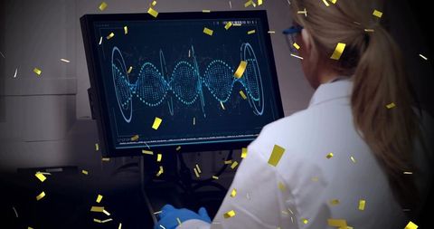 Laboratory scientist analyzing waveform on monitor wearing blue gloves with gold confetti