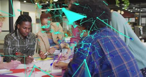 Creative diverse team brainstorming around table with holographic network visualization