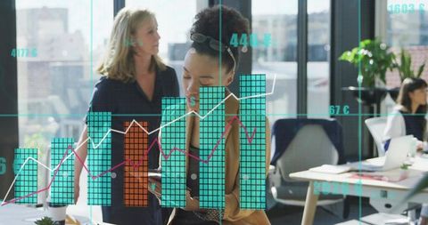 Business Team Analyzing Financial Graph Overlay in Modern Office