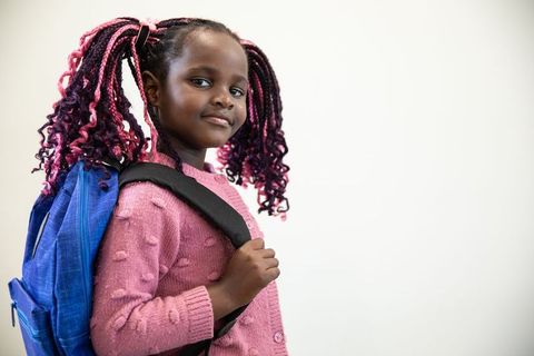 Confident Girl Carrying Backpack Posing in Studio