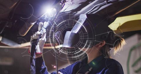 Female welder repairing car undercarriage with augmented reality HUD overlay