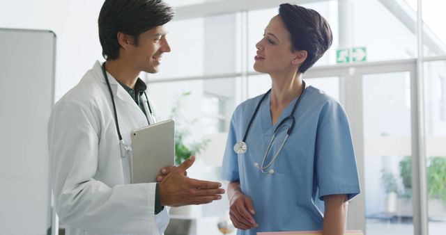 Healthcare professionals in a hospital setting discussing patient care, making medical decisions with a stethoscope, charts. Perfect for illustrating medical teamwork, professional collaboration, hospital environment, healthcare management, patient care planning, medical discussions, or any content dealing with medical field employees.