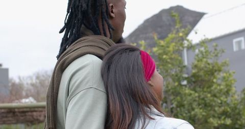 Interracial Couple Leaning Outdoors, African American Man with Dreadlocks and Indian Woman in Pink H