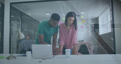 Focused Colleagues Analyzing Documents in Modern Office Space
