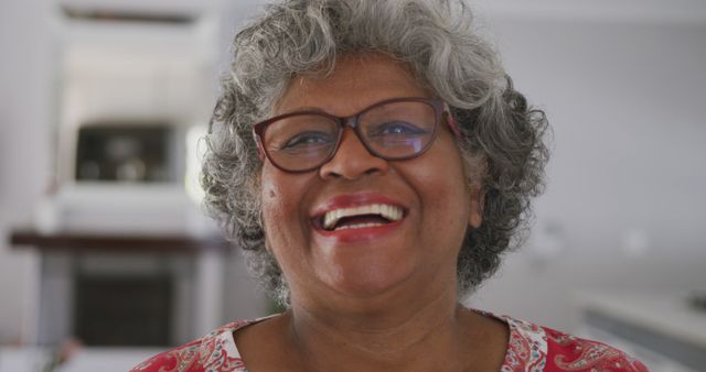 Joyful Elderly Woman with Glasses and Curly Gray Hair Smiling - Download Free Stock Images Pikwizard.com