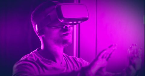 African American Man Immersed in VR Technology with Purple Lighting - Download Free Stock Images Pikwizard.com