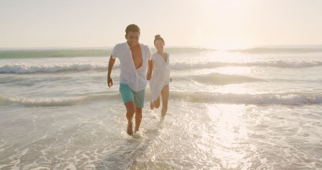 Couple Running and Laughing on Beach at Sunset - Download Free Stock Images Pikwizard.com