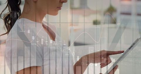 Businesswoman Analyzing Digital Data on Tablet with Graph Overlay