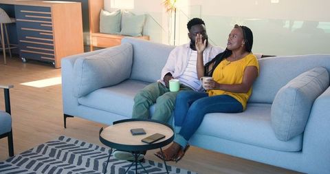 Couple Enjoying Coffee and Conversation in Cozy Modern Living Space