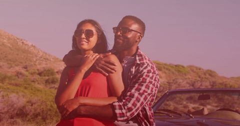 Romantic couple embracing by seaside in gentle light