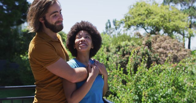 Couple embracing with joy in an outdoor setting, expressing love and happiness. This image is perfect for illustrating themes around relationships, romance, togetherness, and positivity in promotional materials, websites, social media posts, or health and lifestyle blogs.