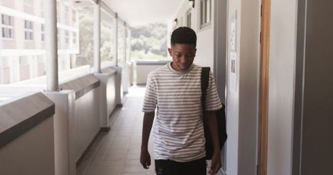 Young African American Boy Exploring School Hallway