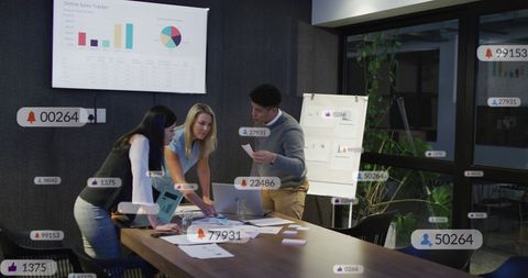 Diverse Colleagues Collaborating with Social Media Analytics Icons Overlay