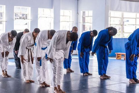 Martial arts students practicing respect in training hall