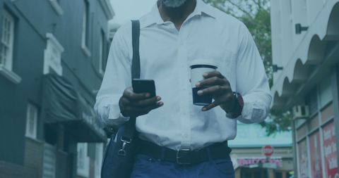 Businessman Walking with Coffee and Smartphone in Urban Area - Download Free Stock Images Pikwizard.com