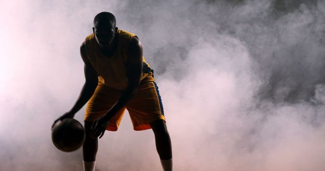 Basketball Player Dribbling Ball Amidst Smoky Background - Download Free Stock Images Pikwizard.com