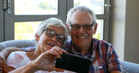 Senior Couple Taking Joyful Selfie on Sofa Indoors - Download Free Stock Images Pikwizard.com