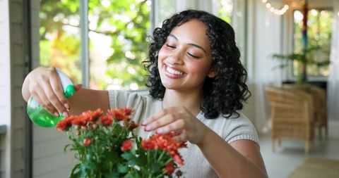Young Woman Enjoying Gardening on Sunlit Porch