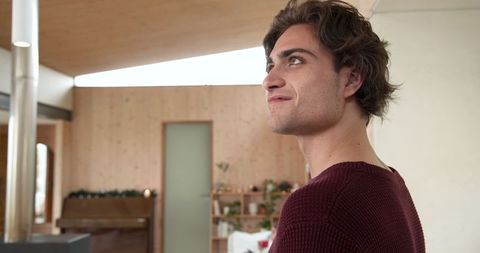 Young Man Standing in Cozy Scandinavian Living Room