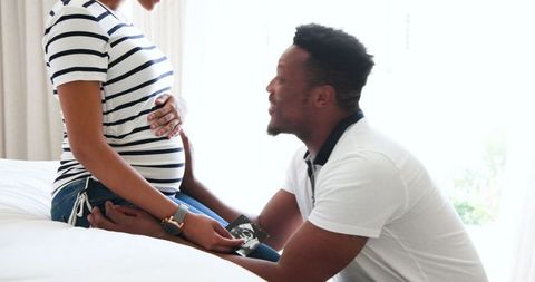 Expectant Couple Sharing Joy and Pointing at Ultrasound