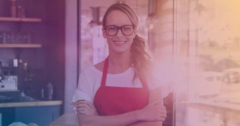 Confident Female Cafe Owner Wearing Apron in Cozy Cafe