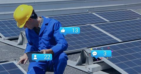 Technician inspecting rooftop solar panels with tablet wearing yellow hard hat