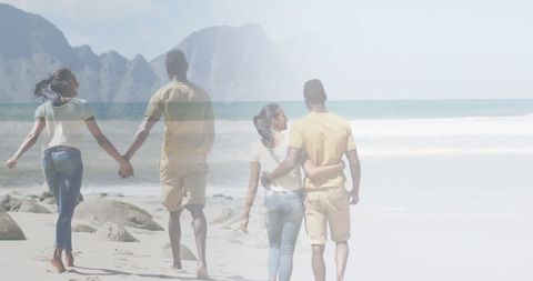 Romantic african american couple walking and embracing on beach