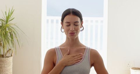 Woman Practicing Mindfulness at Home Near Open Balcony