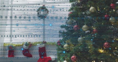 Glowing Christmas tree illuminating cozy living room with stockings, garland and wreath