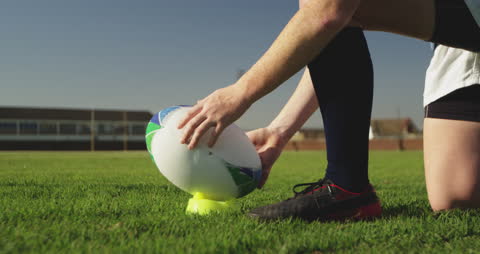 Rugby Player Preparing Place Kick on Sunny Field