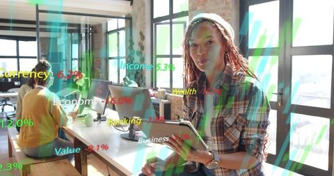 Young professional analyzing financial data on tablet in modern coworking office