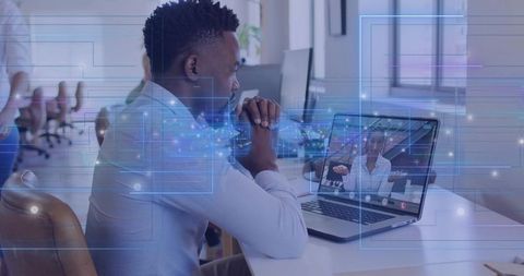 Office worker engaging in virtual meeting with digital overlay for remote collaboration