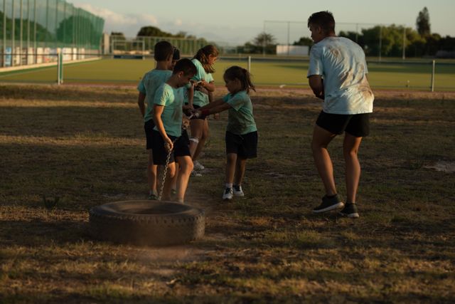 Children Exercising with Coach at Outdoor Boot Camp - Download Free Stock Images Pikwizard.com