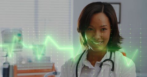 Smiling doctor with digital heartbeat interface in hospital