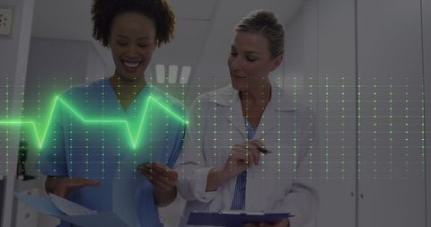 Healthcare Professionals Discussing Patient Charts with ECG Overlay - Download Free Stock Images Pikwizard.com